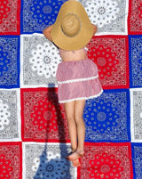 red white blue blanket with girl with hat