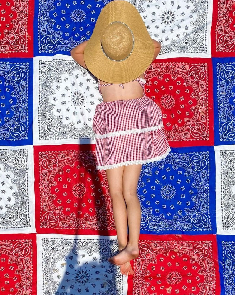 red white blue blanket with girl with hat